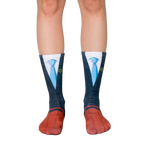 A pair of crew socks showcasing a navy suit and blue tie design.  The socks have red shoe details and yellow scales of justice on the tie. [lf]