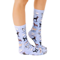 Lifestyle shot of a person wearing the Dog Breeds socks, showing how they look when worn. [lf]