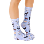 Lifestyle shot of a person wearing the Dog Breeds socks, showing how they look when worn. [lf]
