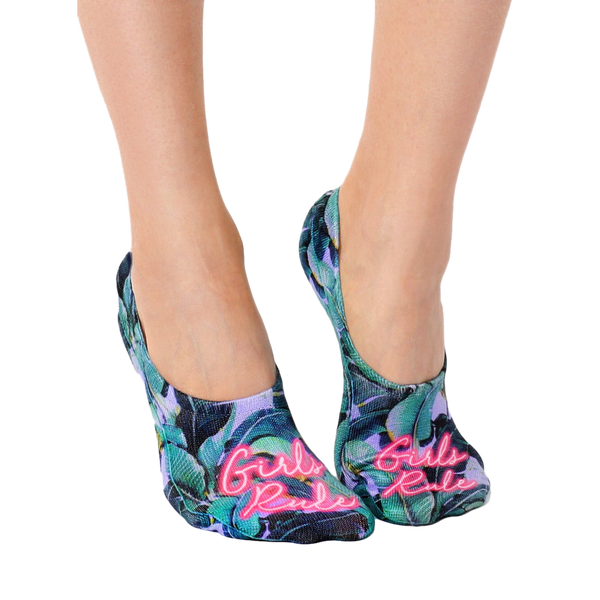 Lifestyle shot of a woman's feet wearing the 'Girls Rule' no-show socks. [lf]