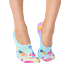 Lifestyle shot of a woman's feet wearing the 'No Bad Vibes' no-show socks. The socks are visible from the ankles down. [lf]