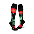 Pair of black knee-high socks adorned with red poppies and green foliage. 