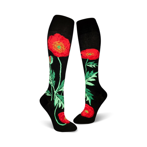 Pair of black knee-high socks adorned with red poppies and green foliage. 