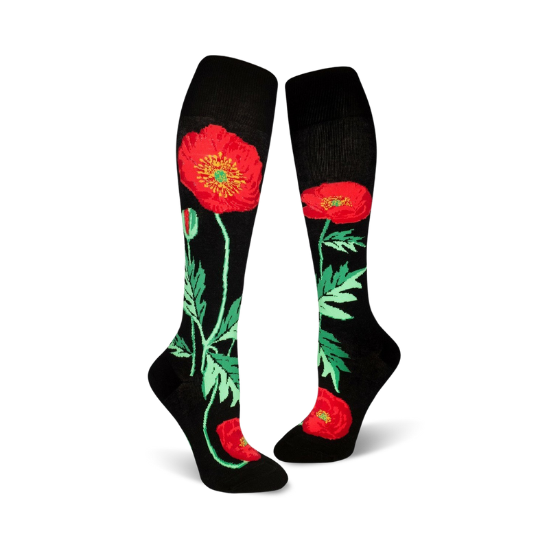 Pair of black knee-high socks adorned with red poppies and green foliage. 