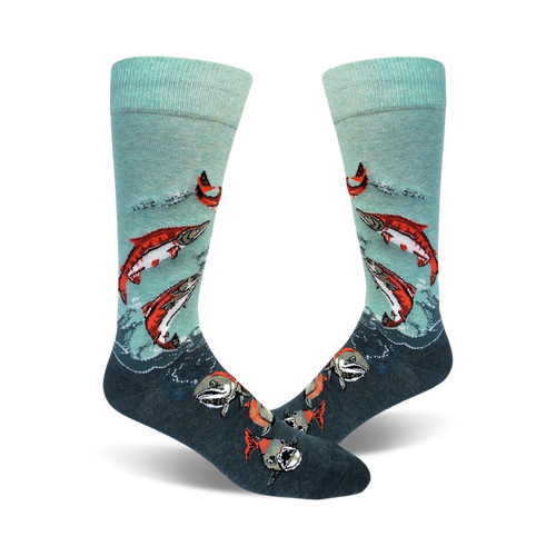 A pair of teal and dark grey crew socks with a design of red sockeye salmon leaping from the water. 
