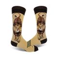 A pair of tan crew socks with a brown-toned lion graphic. The lion is walking toward the viewer. Brown cuff.