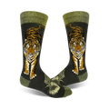 A pair of crew socks with a detailed tiger illustration in orange and black against a dark green background. The socks have a green cuff.