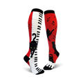 A pair of red and white knee-high socks with a piano keyboard and playful black cats.  Musical notes are also featured.