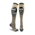 A pair of tan knee-high socks with a wood grain pattern and two raccoons peeking from a tree hole.  The socks have dark gray toes and heels, and a small heart with arrow detail at the ankle.