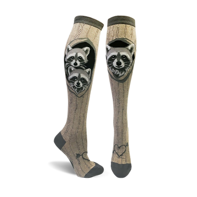 knee high raccoon socks for women featuring 2 raccoons peeking out of a hole in the wood grain pattern.  