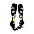A pair of black knee-high socks with a whimsical pattern of white daisies and green stems.