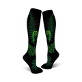 Pair of black knee-high socks featuring bright green ferns and fiddleheads. Botanical print on a black background.