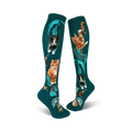 A pair of teal knee-high socks showcasing cats with mermaid tails.  Other designs include seahorses, starfish, and seashells.