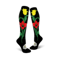 Pair of black knee-high socks with red and yellow tulips and green stems. A white flower is at the ankle.