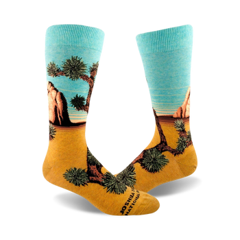 mens crew socks with a joshua tree desert plant and rock pattern. colors are brown, green, and light blue.  