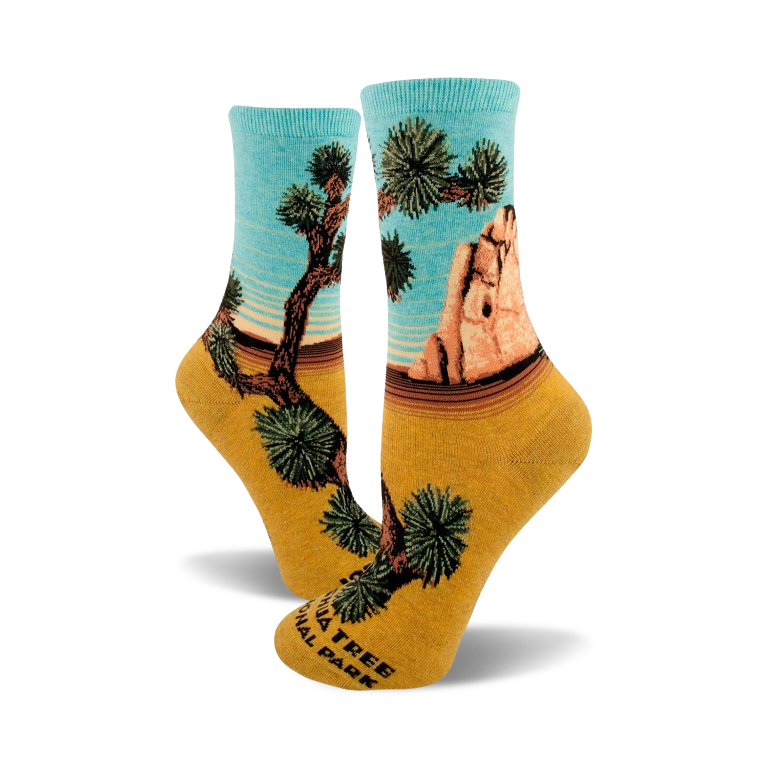 A pair of women's crew socks showcasing a Joshua Tree National Park design. The socks are teal and mustard yellow, depicting a desert landscape with iconic Joshua trees and rock formations.