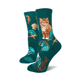 teal socks with orange mermaid-tailed cats, green jellyfish, pink seahorse, brown starfish, shells, green seaweed. women's crew socks.   