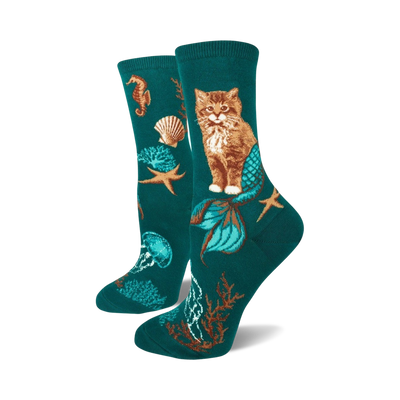 teal socks with orange mermaid-tailed cats, green jellyfish, pink seahorse, brown starfish, shells, green seaweed. women's crew socks.   