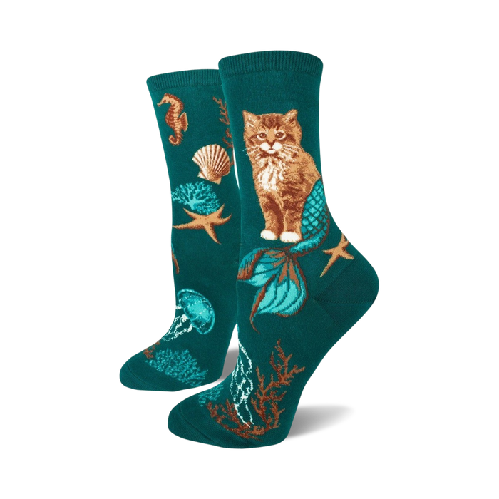 teal socks with orange mermaid-tailed cats, green jellyfish, pink seahorse, brown starfish, shells, green seaweed. women's crew socks.    }}