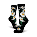 A pair of black crew socks featuring a whimsical pattern of white daisies with yellow centers and green stems.