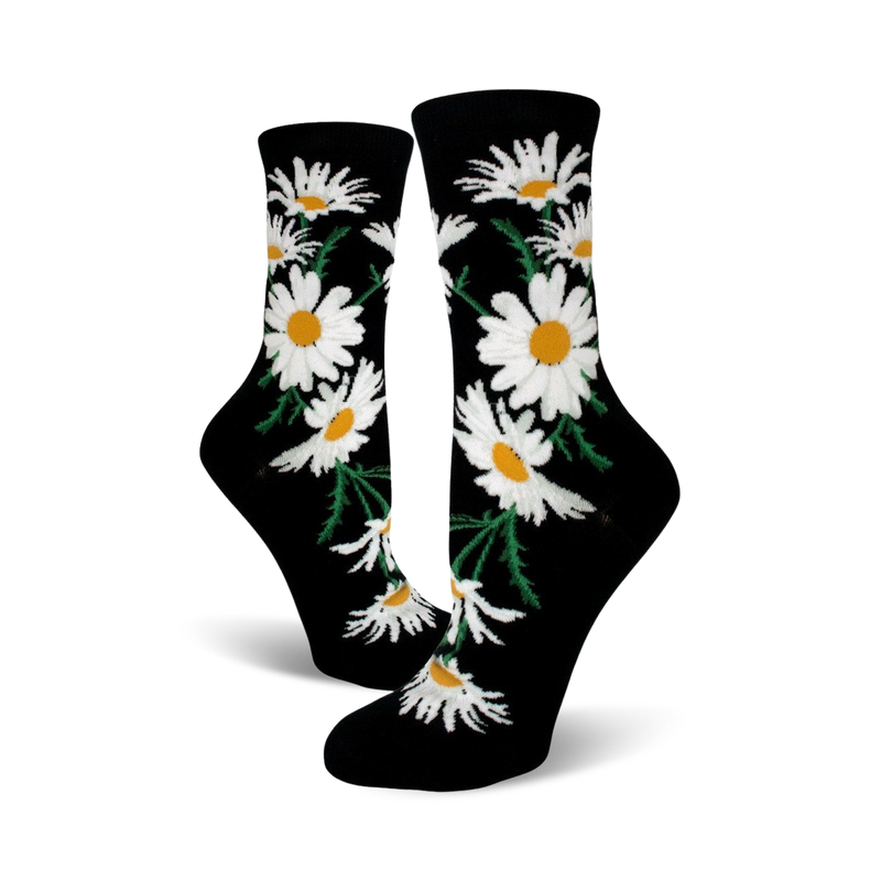 A pair of black crew socks featuring a whimsical pattern of white daisies with yellow centers and green stems.