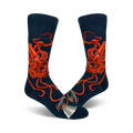 A pair of navy blue crew socks with a detailed illustration of a giant squid in bright orange.  A small whale is visible near the toes.