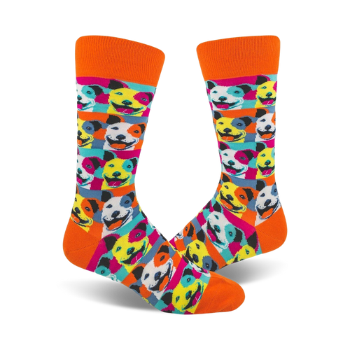 Crew socks with an orange cuff featuring a Pop Art design of smiling pitbulls in bright pink, blue, yellow, and white.