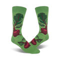 A pair of crew socks showcasing a whimsical illustration of red beets on a green background. The beets are detailed and vibrant against the soft green fabric.