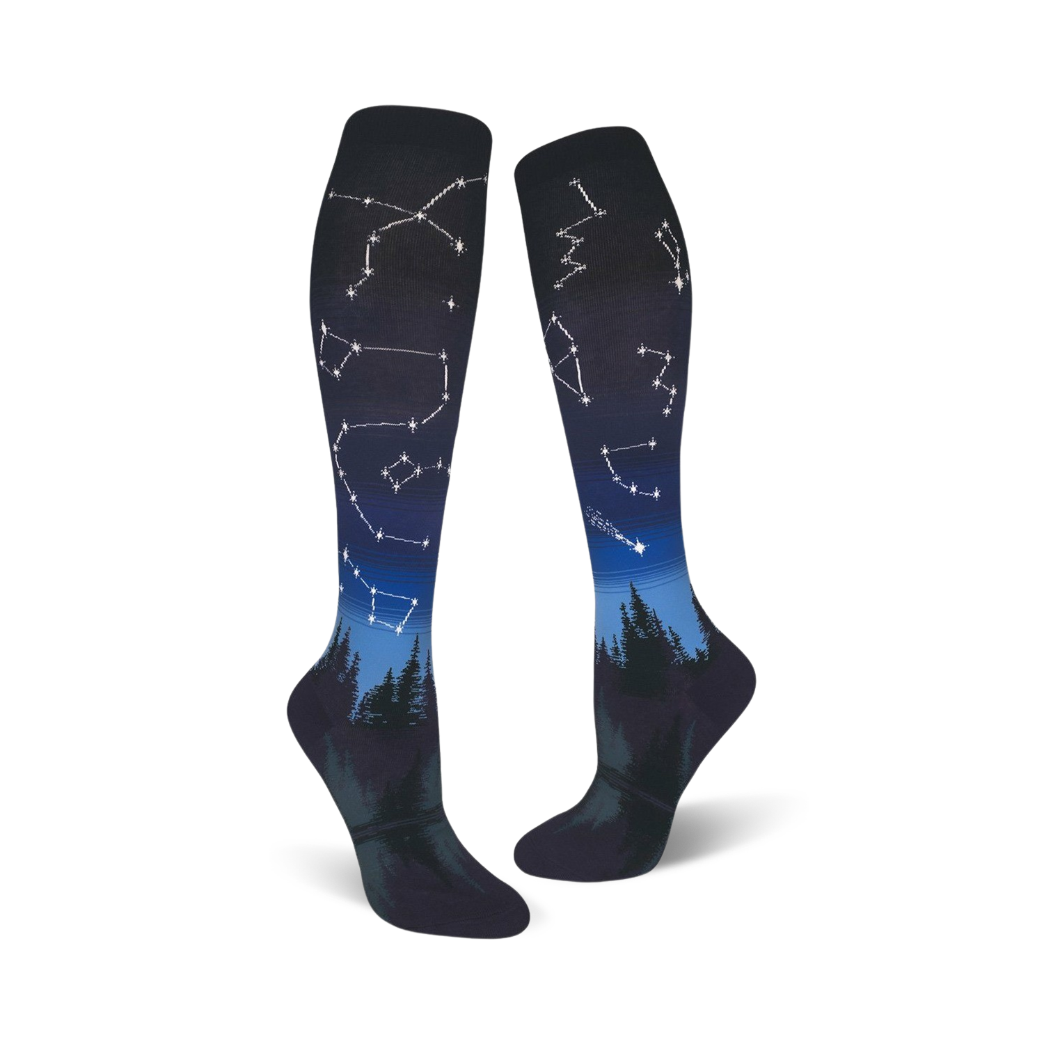Pair of dark blue and black knee-high socks with constellations and a forest silhouette design.