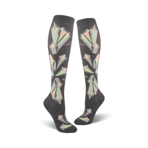 Pair of women's knee-high socks in dark grey with a pastel geometric crystal pattern.  The crystals are iridescent, creating a shimmering effect.