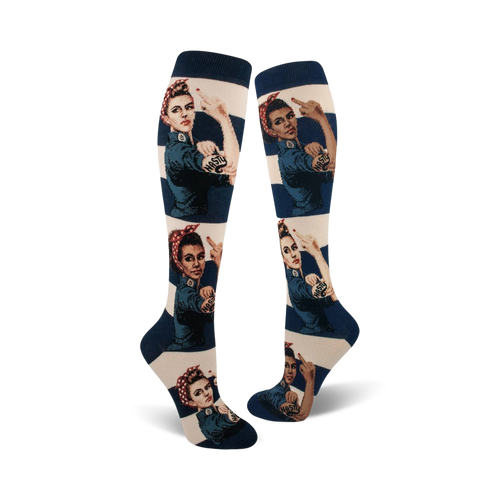 A pair of women's knee-high socks.  They're off-white with navy blue stripes and feature a repeated image of Rosie the Riveter giving the middle finger, with 'Nasty' tattooed on her arm.