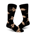 Pair of black crew socks covered in images of golden retrievers.  The dogs are in various poses, and the background is solid black.