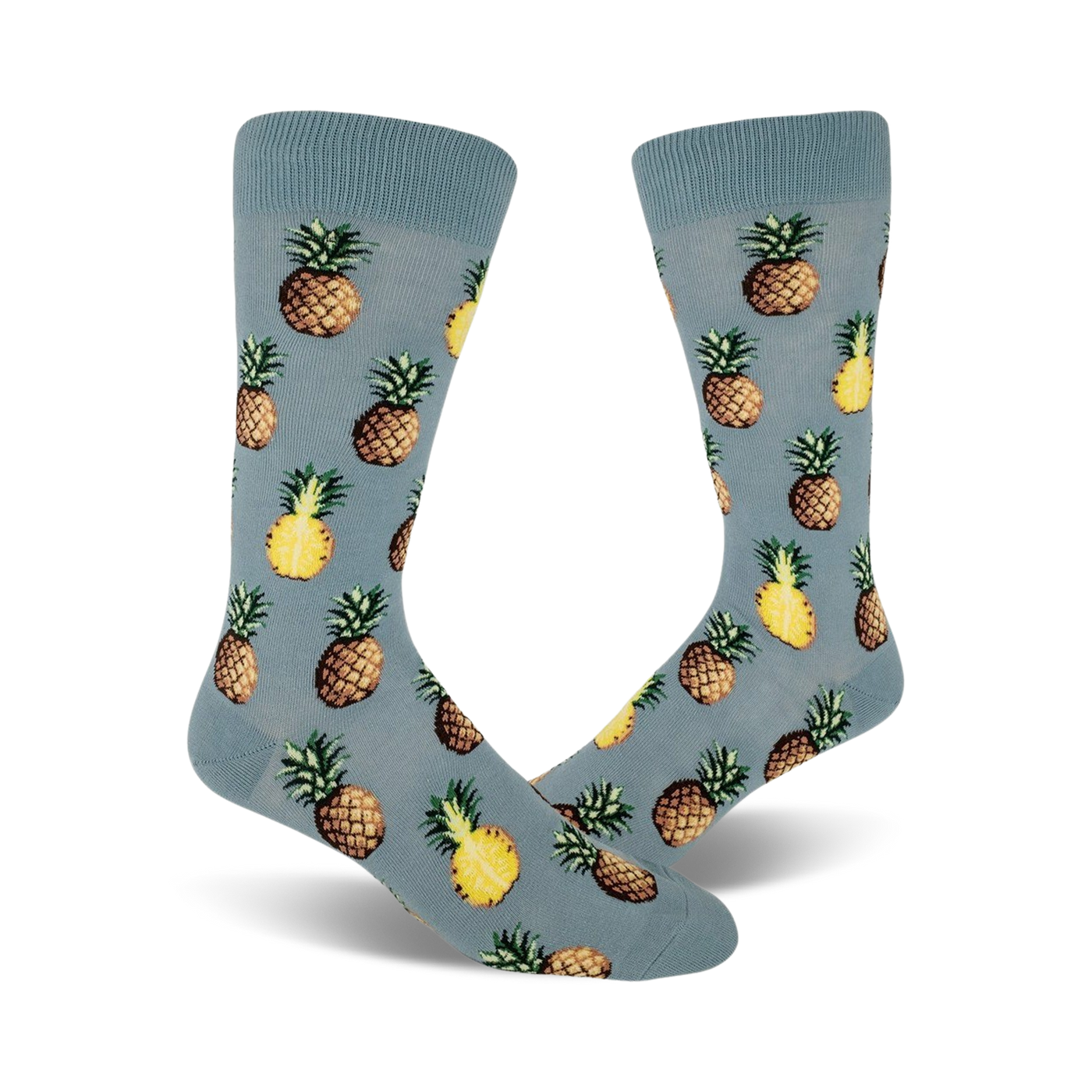 Close up view of a pair of blue crew socks with a repeated pineapple pattern. Pineapples are yellow and brown.