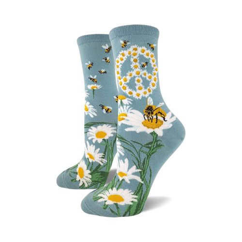 Pair of women's crew socks in teal blue.  Features a peace sign made of daisies and buzzing bees on a field of daisies.