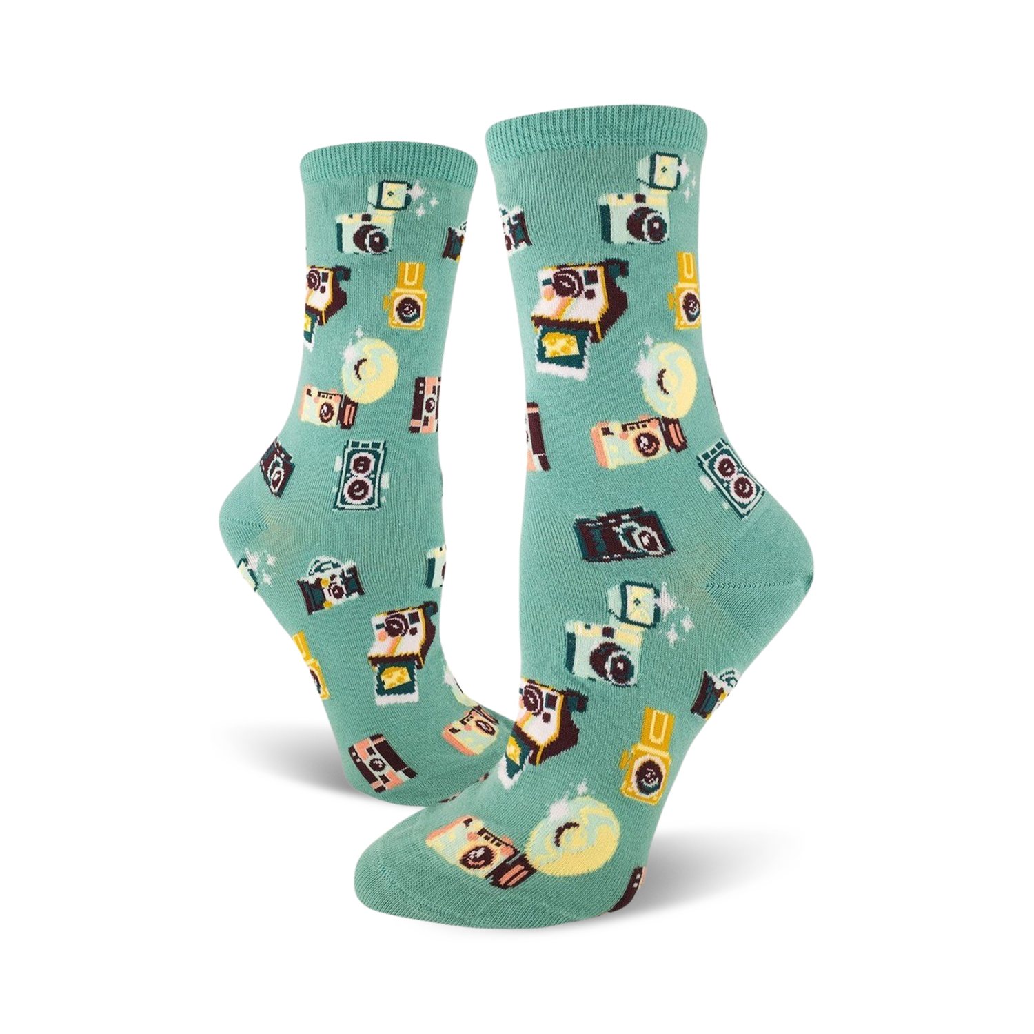 A pair of teal crew socks adorned with a whimsical pattern of retro cameras, film canisters, and sparkling details.