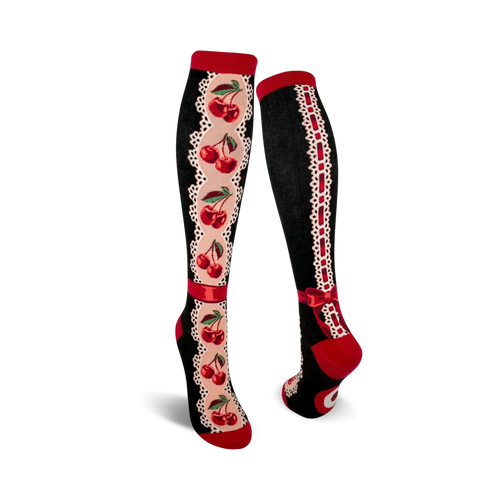 Pair of women's knee-high socks. Black background, red cherries, cream lace accents, and red ribbon bow detail.