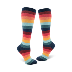 knee-high socks featuring horizontal stripes in a repeating pattern of dark blue, red, orange, yellow, light blue, and green. the socks have a 70s theme. 