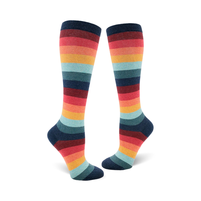 knee-high socks featuring horizontal stripes in a repeating pattern of dark blue, red, orange, yellow, light blue, and green. the socks have a 70s theme.  }}