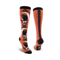 Pair of knee-high socks; orange and black, purple and black. Design features black cats sitting on skulls beneath crescent moons.