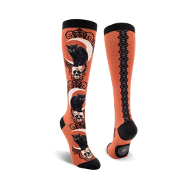 orange knee high socks with black cats, skulls and crescent moons and a lace pattern.  