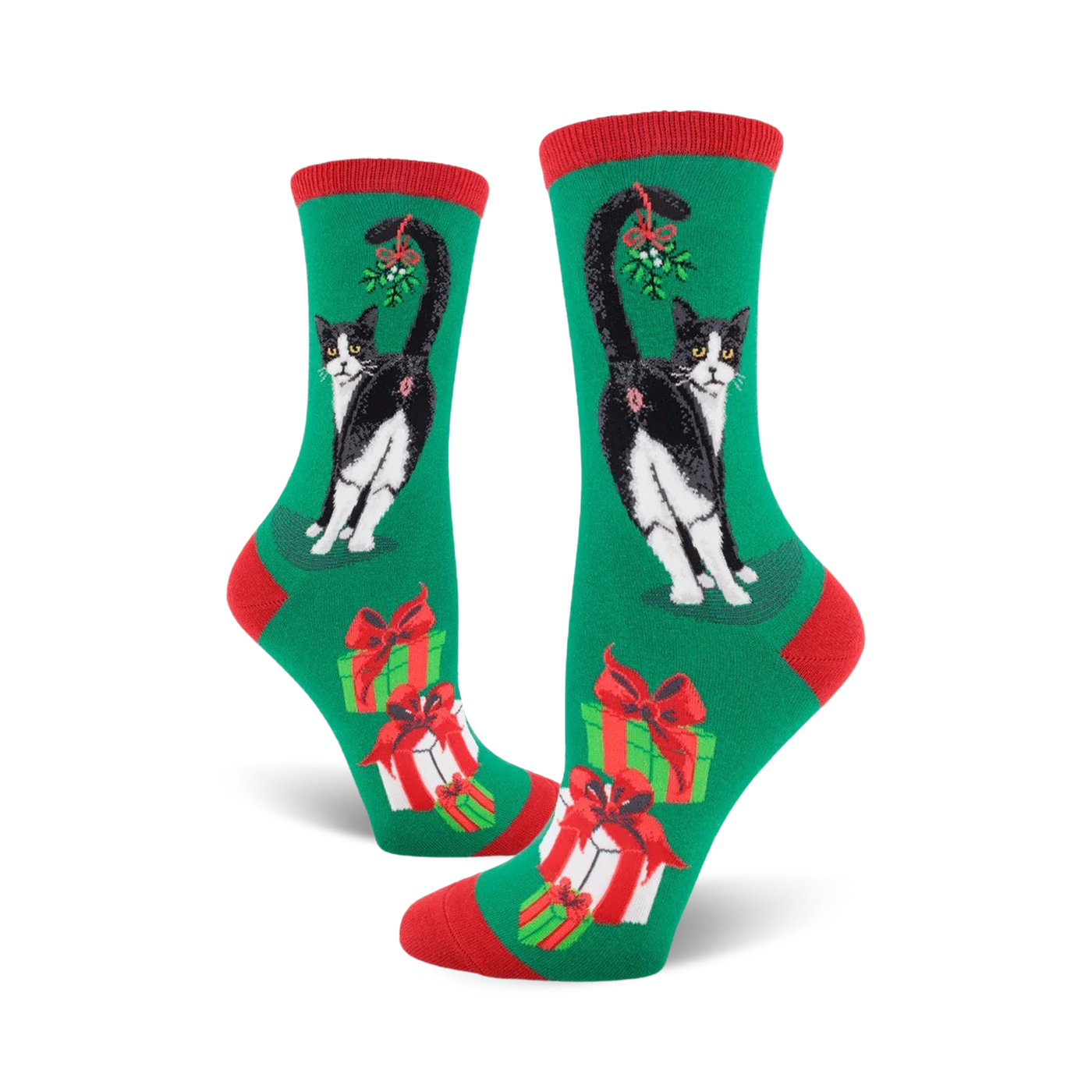 A pair of women's crew socks in green, red, and white. Features a black and white tuxedo cat with mistletoe and presents.