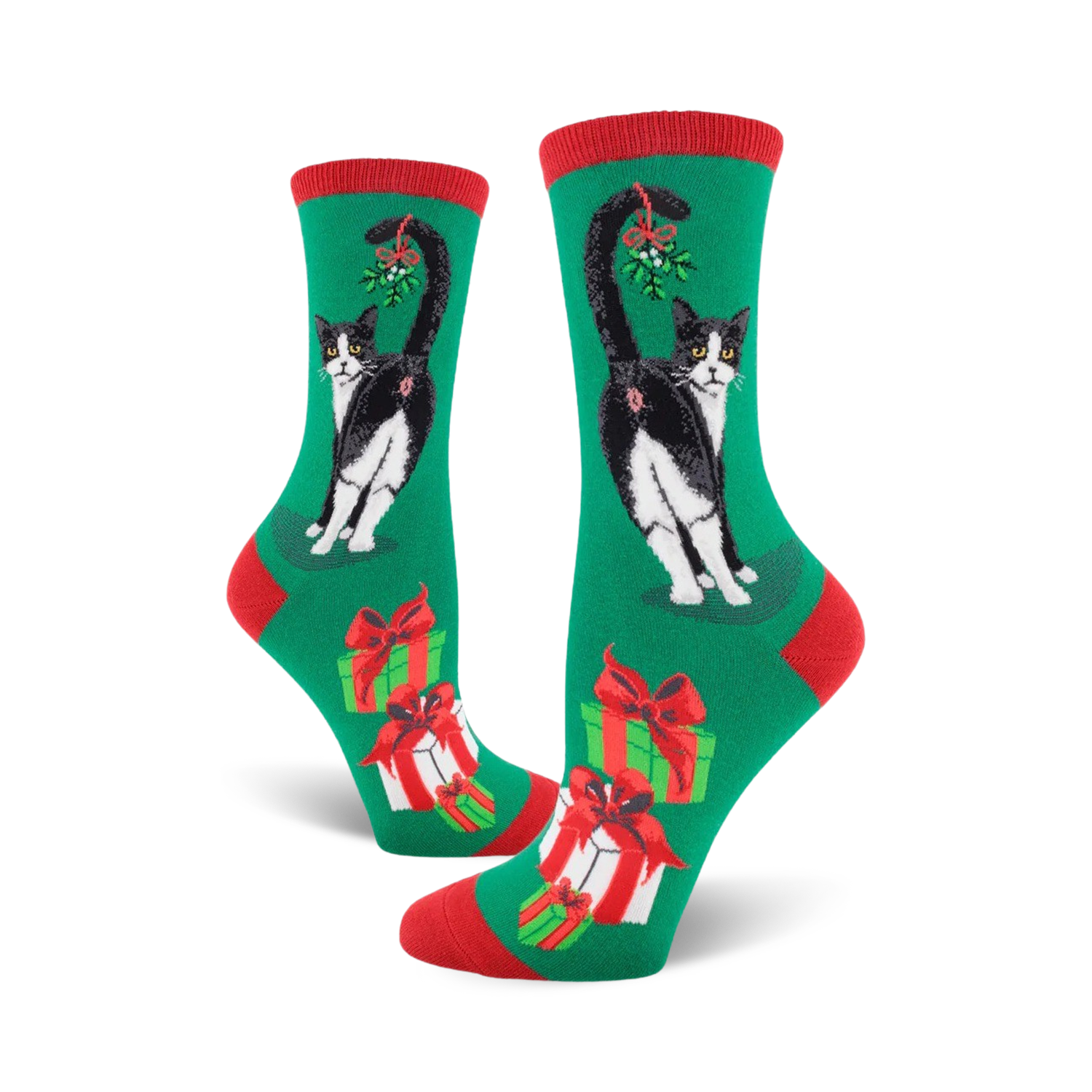 A pair of women's crew socks in green, red, and white. Features a black and white tuxedo cat with mistletoe and presents.