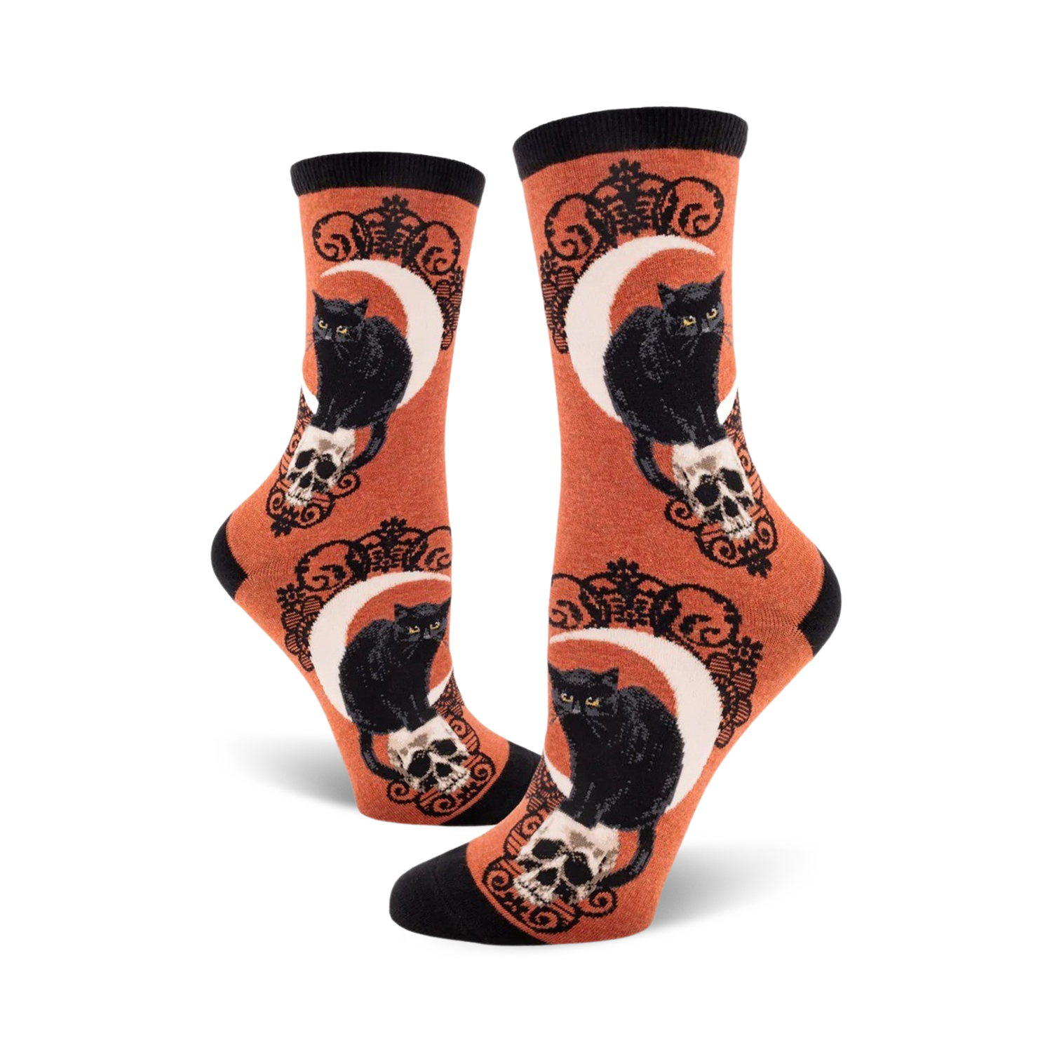Crew socks in orange and purple featuring black cats perched on skulls beneath a crescent moon. Ornate detailing.