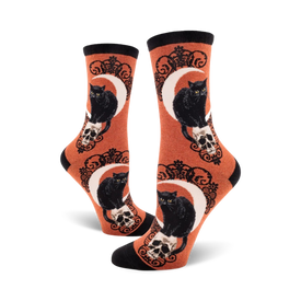 black cat moon crew socks: orange cat skull pattern with crescent moon design for women.    