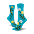 Pair of crew socks in teal and mauve featuring a whimsical dandelion design. Yellow dandelions and seed heads are scattered on a solid background.