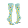 Pair of women's knee-high socks in pastel blue with a repeating pattern of yellow forsythia flowers and green stems.