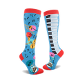 Pair of knee-high socks; one sock shows musical instruments and notes on a light blue background, the other shows a piano keyboard.  Red, pink, yellow, and teal accents.