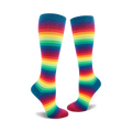 Pair of rainbow striped knee-high socks. Colors include red, orange, yellow, green, blue, indigo, and violet stripes on a dark teal base.