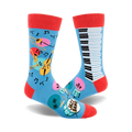 Crew socks in blue with red cuffs.  Features a piano keyboard, musical instruments (trumpet, cello), and music notes. 
