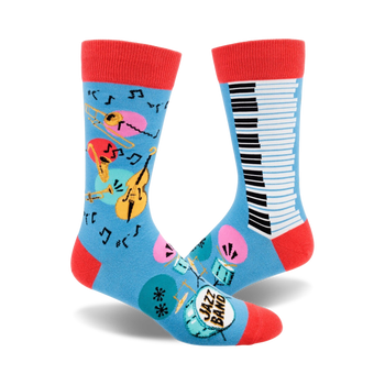 blue crew socks with musical instruments design, including saxophone, trumpet, drums, maracas, double bass, piano keys, and musical notes.  